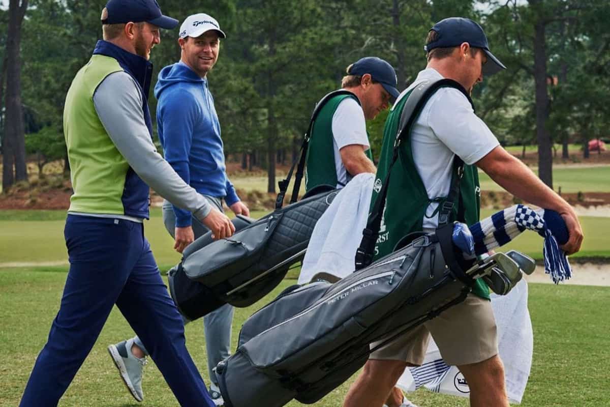 golfers and Pinehurst caddies walk through Pinehurst golf courses